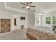 Spacious primary suite with a tray ceiling, ceiling fan, and walk-in closet at 466 Gianna Ln, Goose Creek, SC 29445