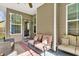 Screened-in patio with seating, ceiling fan, and well-lit view of the outside yard at 466 Gianna Ln, Goose Creek, SC 29445