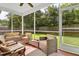 Screened in patio with outdoor seating, ceiling fan and views of the fenced backyard at 466 Gianna Ln, Goose Creek, SC 29445