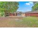 Expansive backyard boasts a screened-in porch, brick patio, lush greenery, and mature shade trees at 4729 Lang Ridge Dr, North Charleston, SC 29405