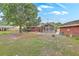 Spacious backyard featuring a large tree, screened-in porch, patio, and mature landscaping at 4729 Lang Ridge Dr, North Charleston, SC 29405