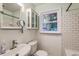 Charming bathroom with beadboard, subway tile surround, a built-in vanity, and a window for natural light at 4729 Lang Ridge Dr, North Charleston, SC 29405