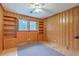 Bedroom featuring wood paneled walls, built-in bookshelves and a window with natural light at 4729 Lang Ridge Dr, North Charleston, SC 29405