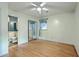 This bedroom has hardwood floors, a ceiling fan, and direct access to an ensuite bathroom at 4729 Lang Ridge Dr, North Charleston, SC 29405