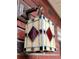 Close-up of a stained-glass exterior light fixture, mounted on a brick wall at 4729 Lang Ridge Dr, North Charleston, SC 29405