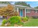 Charming brick home showcasing a vibrant maple tree and inviting blue front door at 4729 Lang Ridge Dr, North Charleston, SC 29405