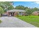 Charming brick home featuring a gravel driveway, carport, and landscaped front yard at 4729 Lang Ridge Dr, North Charleston, SC 29405