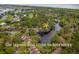 Scenic aerial view of a lagoon with nearby townhomes and abundant greenery at 491 Sea Cloud Cir, Edisto Island, SC 29438