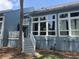 Condo back exterior featuring balconies, large windows, and a charming staircase at 491 Sea Cloud Cir, Edisto Island, SC 29438