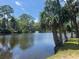 Scenic view of pond with a fountain, framed by trees and lush greenery at 491 Sea Cloud Cir, Edisto Island, SC 29438