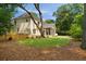Large backyard featuring fenced yard, mature trees, and brick exterior at 499 Lackland Ct, Mount Pleasant, SC 29464