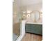 Modern bathroom showcasing glass shower, green vanity, gold fixtures, and stylish mirror at 499 Lackland Ct, Mount Pleasant, SC 29464