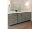 Bathroom vanity with white countertop, sage colored cabinets, gold hardware and fixture with large mirror at 499 Lackland Ct, Mount Pleasant, SC 29464