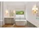 Bright bathroom featuring a freestanding tub, double vanity, and natural light at 499 Lackland Ct, Mount Pleasant, SC 29464