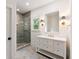 Well-lit bathroom with tiled shower, vanity with white countertops and decorative mirror at 499 Lackland Ct, Mount Pleasant, SC 29464