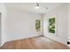 Bright bedroom featuring two windows, wood floors, and a modern ceiling fan at 499 Lackland Ct, Mount Pleasant, SC 29464