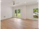Bright bedroom featuring hardwood floors, crisp white walls, and natural light from two large windows at 499 Lackland Ct, Mount Pleasant, SC 29464