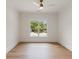 Empty room showcasing a neutral color palette, hardwood flooring and a window with tree views at 499 Lackland Ct, Mount Pleasant, SC 29464