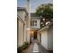 Stylish home featuring a brick chimney, white siding, and a stone pathway leading to a private entrance at 499 Lackland Ct, Mount Pleasant, SC 29464