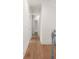 Hallway with neutral colored walls, light-stained hardwood floors, and white trim and doors at 499 Lackland Ct, Mount Pleasant, SC 29464