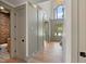 Hallway with high ceilings and multiple doorways, leading to a powder room with a unique patterned wall covering at 499 Lackland Ct, Mount Pleasant, SC 29464