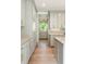 Bright, custom kitchen featuring gray cabinets, marble countertops, and hardwood floors at 499 Lackland Ct, Mount Pleasant, SC 29464