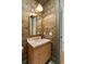 Stylish powder room with a unique patterned wall covering, marble countertop, and a gold-trimmed mirror at 499 Lackland Ct, Mount Pleasant, SC 29464