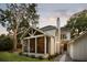 Charming screened porch with comfortable seating, adjacent to a neatly landscaped yard and a quaint stone pathway at 499 Lackland Ct, Mount Pleasant, SC 29464