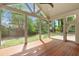Spacious screened-in porch with exposed beam ceiling and expansive views of the backyard at 499 Lackland Ct, Mount Pleasant, SC 29464