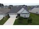 Aerial view of a charming home with a well-maintained lawn and driveway at 516 Tidewater Chase Ln, Summerville, SC 29486