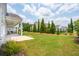 A lush backyard with manicured lawn and ornamental trees offers serene outdoor space at 516 Tidewater Chase Ln, Summerville, SC 29486