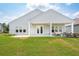Exterior back view showcasing the covered patio and spacious yard, perfect for outdoor enjoyment at 516 Tidewater Chase Ln, Summerville, SC 29486