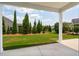 Spacious yard with ornamental trees as seen from the covered patio at 516 Tidewater Chase Ln, Summerville, SC 29486