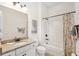 Bathroom features granite countertop vanity, framed mirror, and shower-tub combo at 516 Tidewater Chase Ln, Summerville, SC 29486