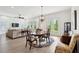 Dining room with chandelier over a wooden table set on an decorative rug with backyard access at 516 Tidewater Chase Ln, Summerville, SC 29486