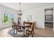 Dining room with chandelier over a wooden table set on an decorative rug with backyard access at 516 Tidewater Chase Ln, Summerville, SC 29486