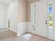 Bright foyer with a sidelight window and decorative rug offers an inviting entrance at 516 Tidewater Chase Ln, Summerville, SC 29486