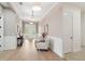 Spacious foyer with elegant lighting, wainscoting, and beautiful wood-look tile flooring at 516 Tidewater Chase Ln, Summerville, SC 29486