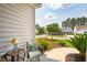Inviting front porch features charming outdoor furniture, a side table and a lovely view of the neighborhood at 516 Tidewater Chase Ln, Summerville, SC 29486