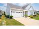 Charming single-story home with well-manicured landscaping, two-car garage, and inviting curb appeal at 516 Tidewater Chase Ln, Summerville, SC 29486