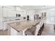 Bright kitchen features a large island with seating, granite countertops, stainless steel appliances, and white cabinetry at 516 Tidewater Chase Ln, Summerville, SC 29486