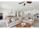 Open concept living room features a large sofa, ceiling fan, and view to the kitchen and dining room at 516 Tidewater Chase Ln, Summerville, SC 29486