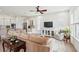 Bright living room features a large sofa, white walls, natural light, and opens to kitchen and dining at 516 Tidewater Chase Ln, Summerville, SC 29486