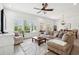 Comfortable living room with lots of natural light, plush seating, ceiling fan, and view to the outdoors at 516 Tidewater Chase Ln, Summerville, SC 29486