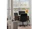 Bright office space featuring a wooden desk set against a large window with natural light and comfortable seating at 516 Tidewater Chase Ln, Summerville, SC 29486