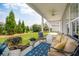 Relaxing outdoor patio area perfect for entertaining, featuring comfortable seating and views of the landscaped backyard at 516 Tidewater Chase Ln, Summerville, SC 29486