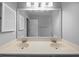 Bathroom featuring a double vanity with framed mirror, and bright vanity lighting at 5488 Altamaha Dr, North Charleston, SC 29420