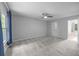 Spacious bedroom with plush carpeting, ceiling fan, and ample natural light from a large window at 5488 Altamaha Dr, North Charleston, SC 29420