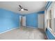 Bedroom with blue walls, carpet, ceiling fan, and window offering plenty of natural light at 5488 Altamaha Dr, North Charleston, SC 29420