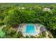 Aerial image of a community pool with lounge chairs and lush landscaping at 5488 Altamaha Dr, North Charleston, SC 29420